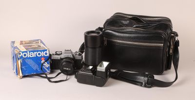 a camera, a camera case, a camera and a box of polaroid