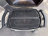 a grill that is sitting on the ground outside