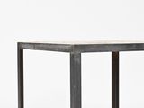 the table is made of metal and has a marble top
