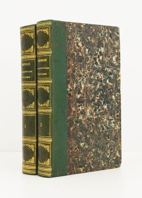two green books sitting on top of each other on a white surface