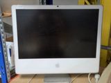an apple computer monitor sitting on top of a wooden desk