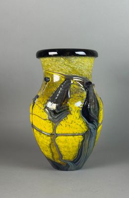 a yellow and black vase with a horse on it