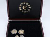 two euro coins in a wooden box with gold stars