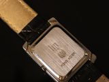 a close up of a watch on a black surface