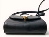 an image of a black purse with a gold clasp