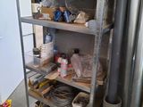 a metal shelf with many items on it in a garage