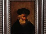 portrait of a bearded man with a black hat and a white beard