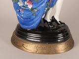 a figurine of a woman in a blue dress
