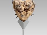 a close up of a sculpture of a heart on a stand