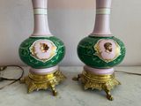 two green vases with pink and gold designs on them