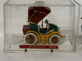 a small toy car in a clear box with an umbrella