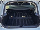 the back of a car with its trunk open and the back of the car filled with luggage