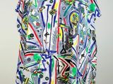 a white mannequin torso with a multicolored shirt on it