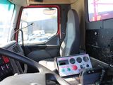 steering wheel of a truck with a laptop on the dashboard