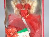 doll in a red box with a red ribbon and a red bow