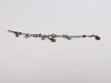 a close up of a beaded bracelet on a white surface