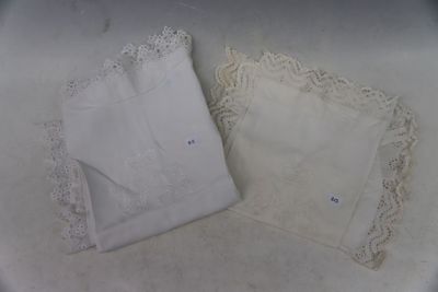 two white handkerchiefs on a white table cloth