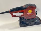 an image of a red and black electric sander on a white surface