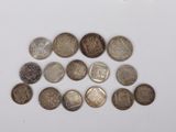 a close up of a pile of coins sitting on top of a white surface