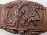 a wooden plaque with a picture of a man and a woman on it