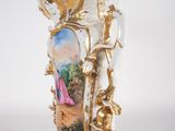 a vase with a painting on it sitting on a table