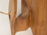 a close up of a wooden object on a white surface