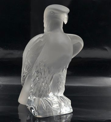 a glass figurine of a bird with a hat on it