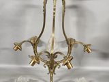 an image of a brass chandelier with four lights