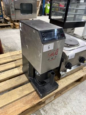 a close up of a coffee machine on a pallet in a warehouse