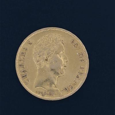 a close up of a gold coin on a black surface