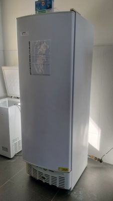 a white refrigerator sitting in a kitchen next to a washing machine