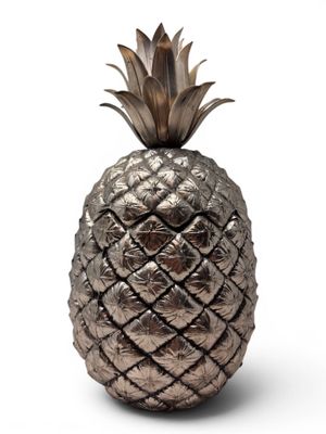 a close up of a metal pineapple on a white background