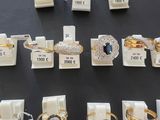 many different types of rings on display in a display case