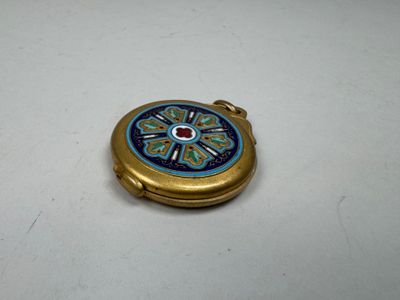 an image of a blue and gold pocket watch on a white surface