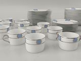 a lot of cups and saucers sitting on a table