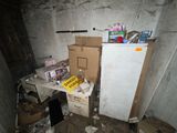 a refrigerator and a refrigerator freezer in a dirty room