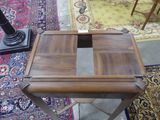 a small wooden table with a drawer on top of it