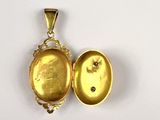 an image of a gold locke with a picture of a woman inside