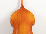 the back of a cello sitting on top of a wooden floor