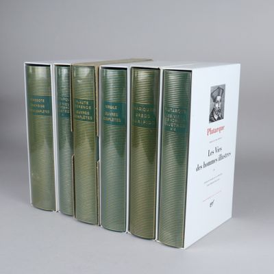 four books in a row sitting on top of a white box