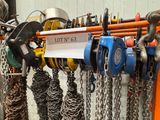 a lot of chains hanging on a rack with a lot of hooks