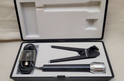 a black and white box with a pair of tools in it