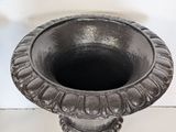 a black vase sitting on a white table