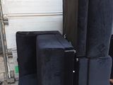 four speakers sitting on a pallet in front of a garage door