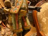 a statue of a man holding a sword in a room