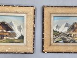 Deux tableaux représentant une maison et une montagne sont accrochés au mur.