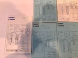 several papers are sitting on a table with a calculator and a check