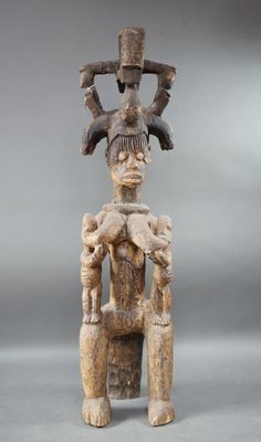 a close up of a statue of a person sitting on a chair