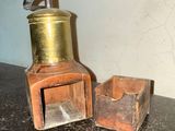 a small wooden box next to a small metal container