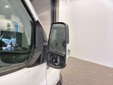 a white van with a broken mirror in a garage